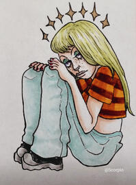 A young woman with long blonde hair sitting with her knees pulled up and her head resting on her legs