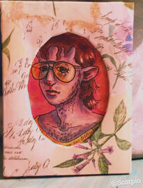 A framed portrait of a satyr with brunet hair and large glasses. The frame is softly floral in design with an oval window.